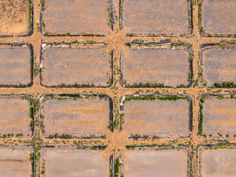 Aerial view of the Quincy Waste Water Treatment facility featuring a grid of rectangular ponds with dry earth and sparse vegetation in Quincy, Washington, United States.