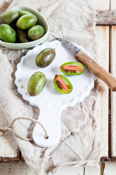 Sliced and whole mini kiwis on plate