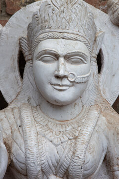 Marble statue of a Hindu goddess with crown and nose ring