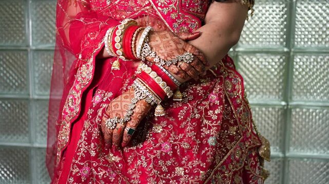 Indian bride wearing traditional red wedding lehenga and bangles in Uttarakhand India