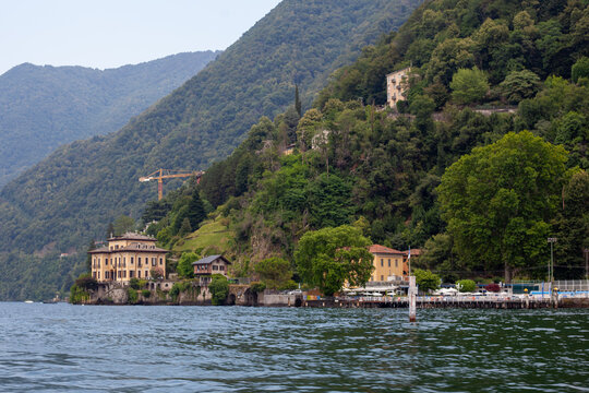 Historic Villa Geno on Lake Como Shoreline with Lush Mountain Background Italy.