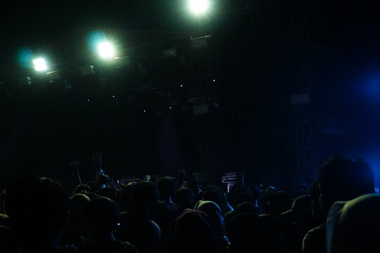 Outdoor Night Concert with Bright Stage Lights and Large Audience