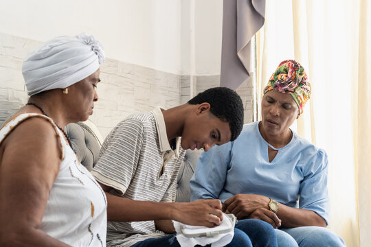 Black family learning embroidery skill passing tradition