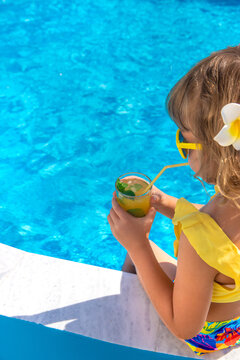 Child with juice in the pool. Selective focus.