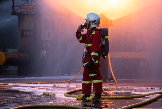 Firefighter wearing full protective equipment and breathing apparatus taking a break