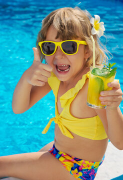 Child with juice in the pool. Selective focus.