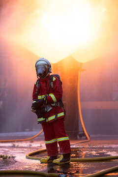 Firefighter wearing full protective equipment and breathing apparatus taking a break
