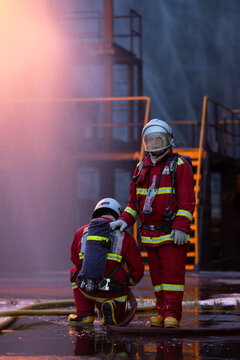 Firefighter wearing full protective equipment and breathing apparatus taking a break
