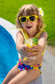 Child with juice in the pool. Selective focus.