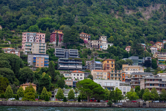 Multicolor houses architecture, Green trees Hillside Houses and Villas View from Water Lake Como Italy.