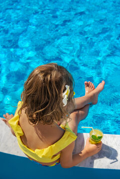 Child with juice in the pool. Selective focus.
