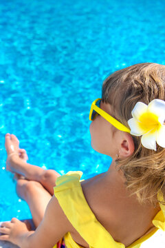 A child resting near a pool. Selective focus.