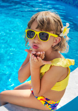 A child resting near a pool. Selective focus.