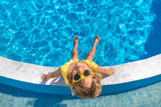 A child resting near a pool. Selective focus.