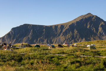 Fototapeta premium Beautiful Sunset Over a White Sandy Beach and Mountains in Lofoten, Norway