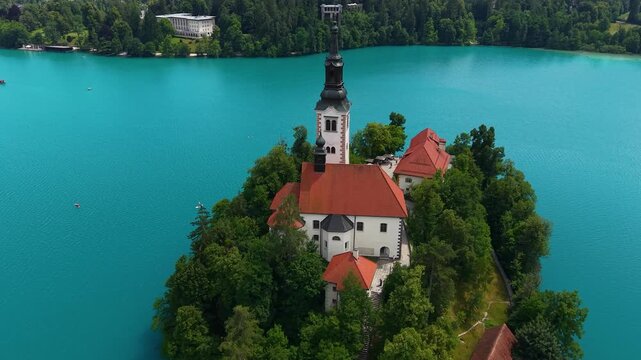 Lake Bled Island, Slovenia. Drone Shot of Catholic Church and Tower in Green Grove Surrounded With Turquoise Alpine Water
