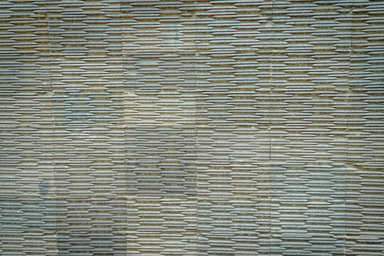 Close-up of a woven bamboo surface with repeating horizontal lines, natural fibers, and subtle variations in earthy tones.