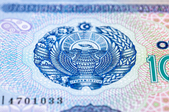 A 2017 banknote of 10000 Uzbek soums. The obverse depicts the state emblem. The reverse side of the banknote features an image of the Senate building in Tashkent.