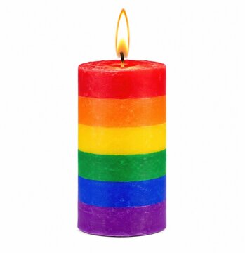 Burning rainbow striped candle isolated on a white background