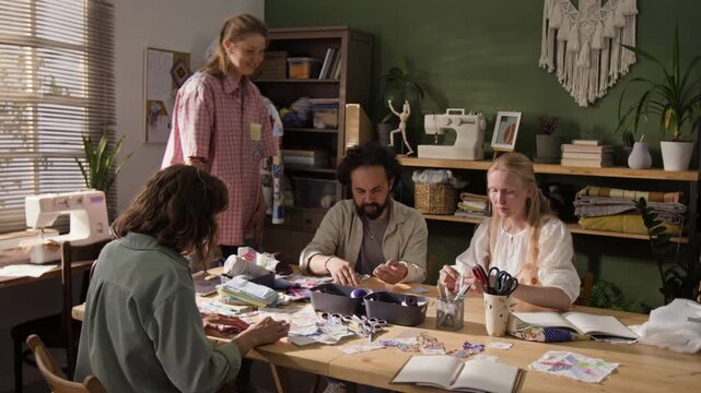 Group of Caucasian adults participating in sewing workshop, discussing fabric patches with female instructor. Footage serves well for marketing creative craft classes or hobby school advertisements