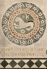 Naklejka premium LUCCA, ITALY - JUNE 23, 2026: The detail of medieval marble intarsia (lion) of church Cattedrale di San Martino by unknown artist (1210 – 1230).
