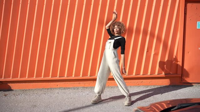 A Trendy Outfit Displayed in Front of a Vibrant and Bright Orange Wall Background