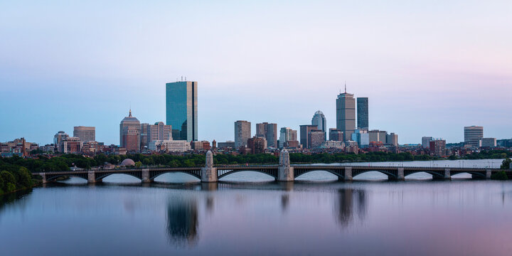 Boston city twilight skyline, skyscrapers, Longfellow Bridge, and soft water reflection on the Charles River in Massachusetts