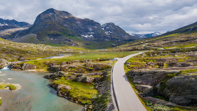Aerial view of the famous Trollstigen mountain road winding through the rugged alpine plateau and stream in Rauma, Norway
