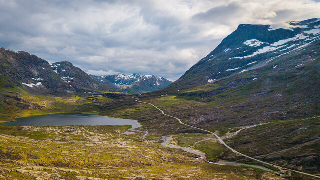 drone perspective capturing a tranquil alpine lake and the Sstigen highland plateau route in M&oslash;re og Romsdal, Norway