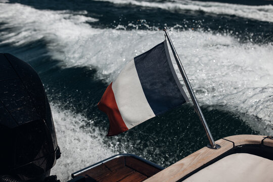 French Flag Flying at the Stern of a High-Speed Motorboat at Sea