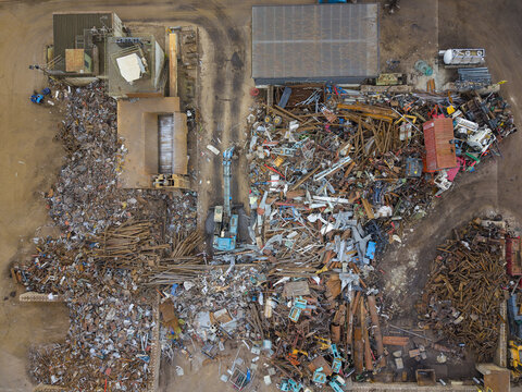 Aerial view of the Agnesberg scrap metal yard with piles of discarded metal, industrial machinery, and sorted scrap materials in Gothenburg, Vastra Gotaland County, Sweden.