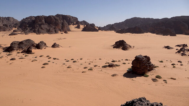 Trip to Sahara desert in Algeria. 
Beautiful african travel photo. Landscape with sandstone 
mountains, sand, sky, nature. Summer vacation in arab country.