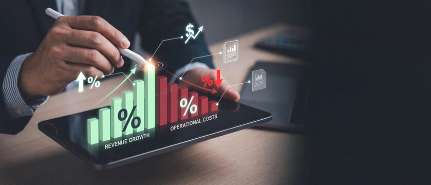 Businessman using tablet to analyze business performance with digital holographic charts showing revenue growth and operational costs