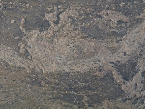 Close up texture of dirty foam and scum floating on the surface of muddy water in a paddy field, depicting environmental pollution, agricultural runoff, and natural soil wet abstract surface