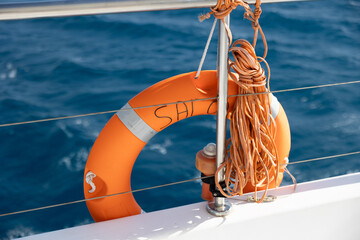 Orange Lifebuoy and Rescue Rope on Sailboat © Валерия Шамрай