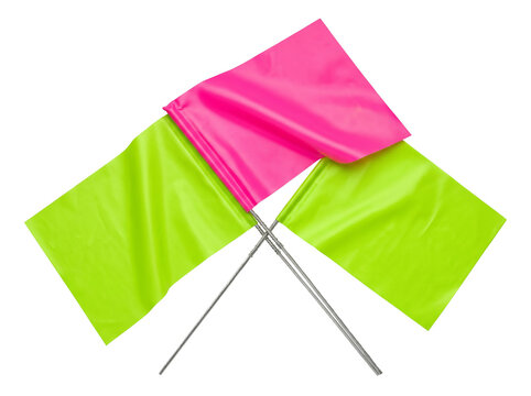 Survey marking flags neon pink lime green wire stake set crossed on black background for construction site location boundaries utility layout map measurement and industrial signaling indicator.