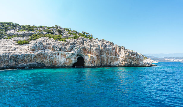 Turquoise waters and ancient Lycian coast of Kekova Island during a boat cruise in Antalya, Turkey.