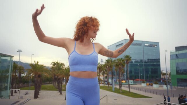 Beautiful red haired young woman with rollerskates having fun outdoors