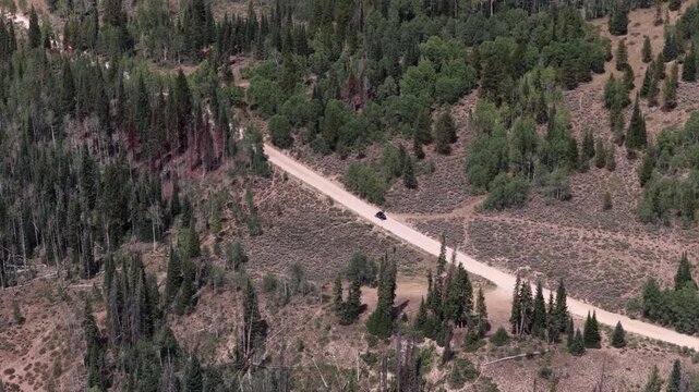 Aerial of UTV on dirt road Soapstone Pass in Uinta Wasatch Cache National Forest in Utah in summer