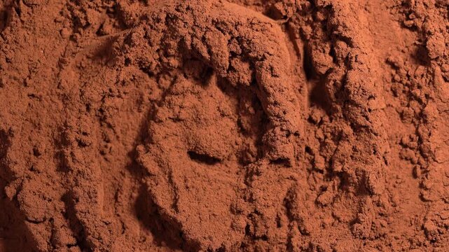 Cocoa powder pile close-up, rotation. Pastry chef. Brown cocoa powder texture circle rotation close-up. Chocolate	
