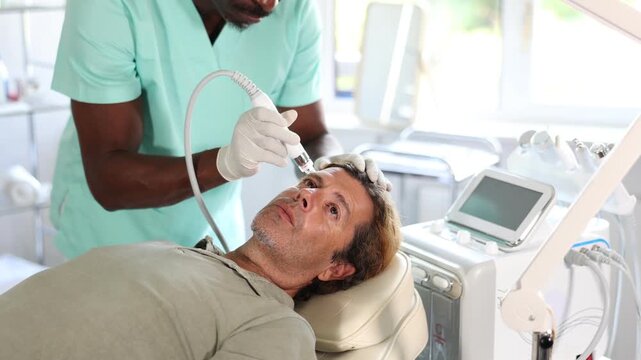 Cosmetologist used Hydrogen Oxygen Hydrating attachment to revitalize client's skin during facial treatment. High quality 4k footage
