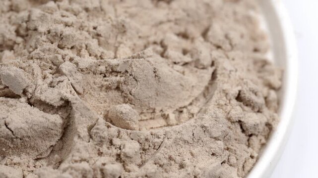Protein powder in a measuring spoon. Bodybuilding, fitness and lifestyle in the gym. The concept of sports, health and nutrition	