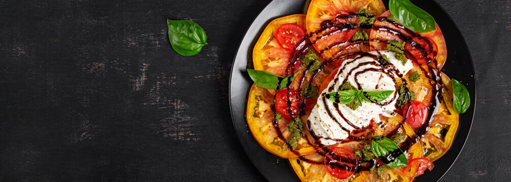 Mediterranean Caprese with Burrata Cheese and Fresh Basil. Top view, bsnner