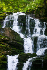 Cascading Waterfall Over Mossy Rocks © Oleksandr