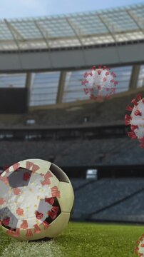 Covid-19 cells against soccer ball on sports stadium