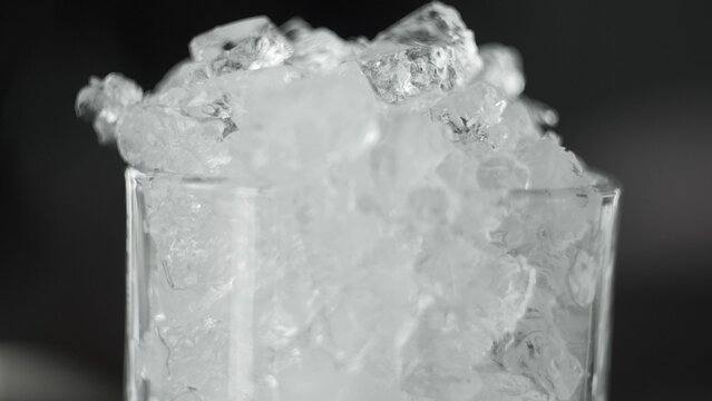 Crushed ice filling a clear glass, creating a refreshing frozen texture and cold beverage concept