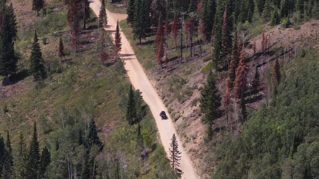 Aerial of UTV off road driving on Soapstone Pass dirt road in Utah in summer in Wasatch National Forest