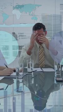 Animation of infographic interface over diverse frustrated man shouting at coworkers in meeting