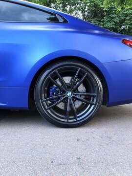 Ukraine, Chernihiv, July 12, 2026. BMW M8 Competition: close-up of the rear wheel and braking system of a blue sports car.