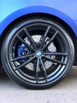Ukraine, Chernihiv, July 12, 2026. BMW M8 Competition: close-up of the rear wheel and braking system of a blue sports car.